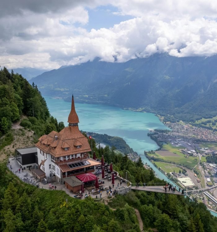 Breathtaking aerial view of Harder Kulm restaurant with Lake Brienz and mountains in Interlaken, Switzerland.